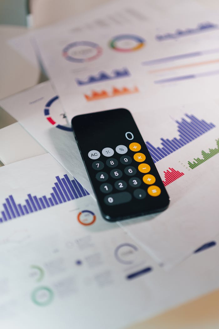 about-us Calculator on graphs showing financial data and analytics. Ideal for business and finance themes.
