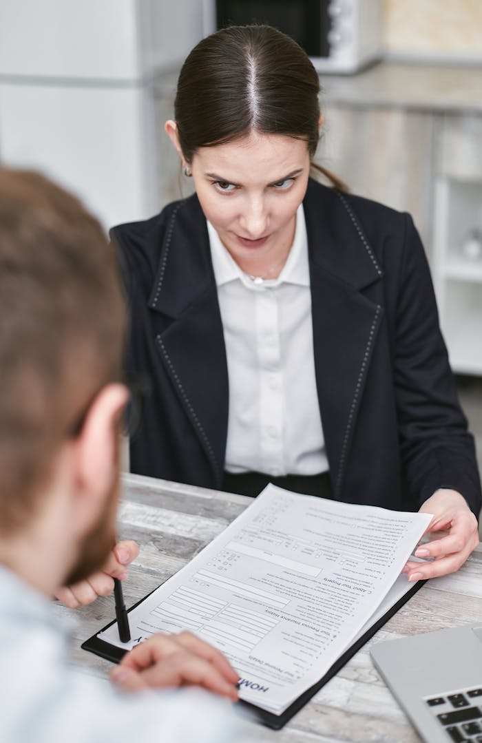 Mastering the First Impression: Your intriguing post title goes here Professional business meeting with a female executive reviewing a contract with a client.